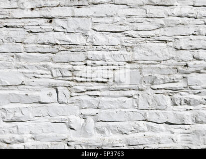 Whitewashed white paint on stone wall close up. Stock Photo