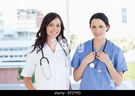 Medical interns standing upright in their short sleeve uniforms Stock Photo