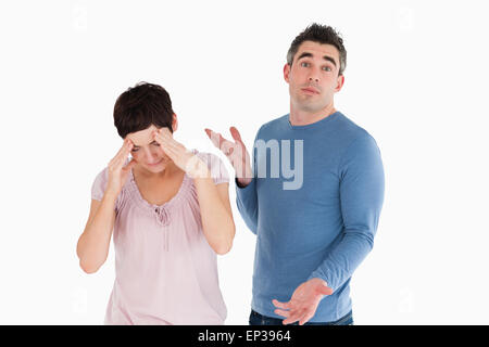 Wife crying while her husband is wondering why Stock Photo