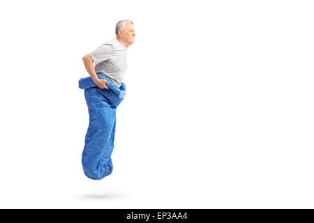 Senior man jumping in a blue sack and smiling isolated on white background Stock Photo