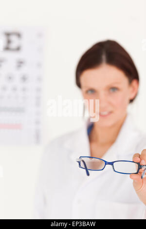 Blurred optician offering glasses Stock Photo