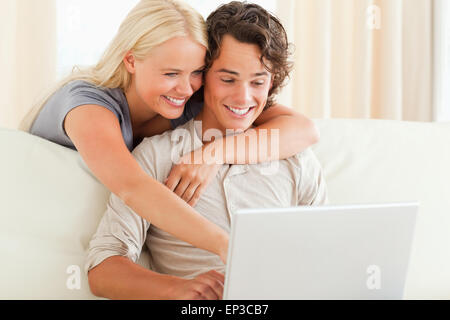 Smiling couple using a laptop Stock Photo