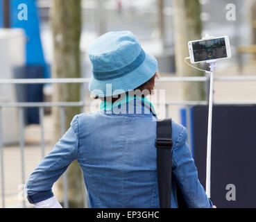 Lake Windermere, Cumbria, UK. 13th May, 2015. UK Weather: Lake Windermere brings out the coach tours & tourists of all nationalities. Group of Japanese tourists take selfies at every opportunity at Brownness Bay front before going for a cruise on Lake Windermere  Credit:  Gordon Shoosmith/Alamy Live News Stock Photo