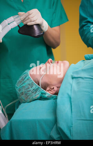 Nurse holding an oxygen mask above the head of patient Stock Photo - Alamy