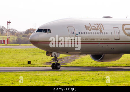 Etihad Airways Boeing 777 taxiing on Manchester International Airport runway. Stock Photo