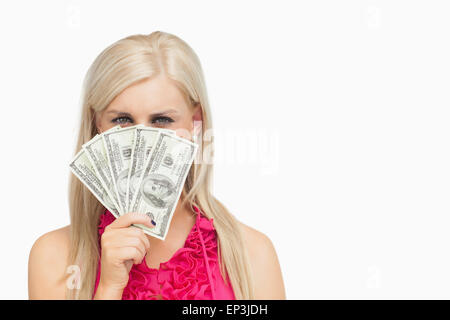 Woman hiding her face with 100 dollars banknotes Stock Photo
