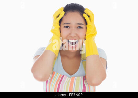Distressed woman wearing apron and rubber gloves Stock Photo