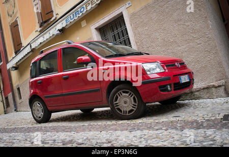 Red fiat Panda parked on a side street in Italy. Stock Photo