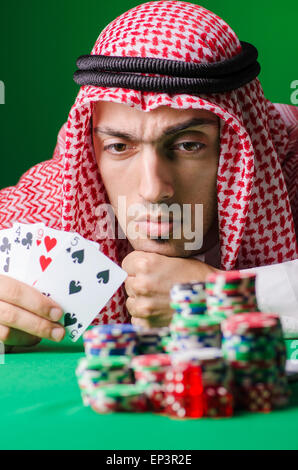 Arab playing in casino - gambling concept with man Stock Photo