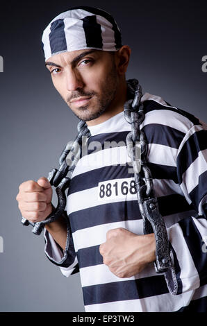 Convict criminal in striped uniform Stock Photo