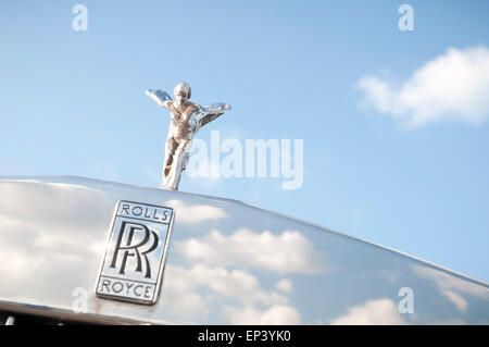 Spirit of Ecstasy on a Rolls-Royce car with blue sky and white clouds Stock Photo