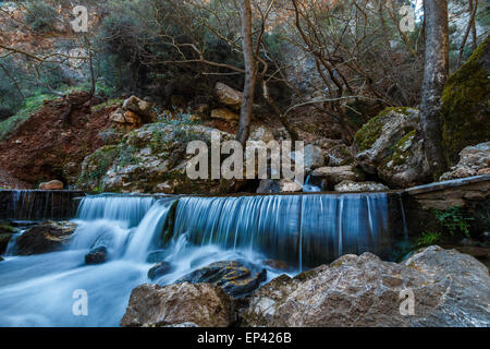 Natural waterfall deep in forest in Greece, long exposure photography Stock Photo