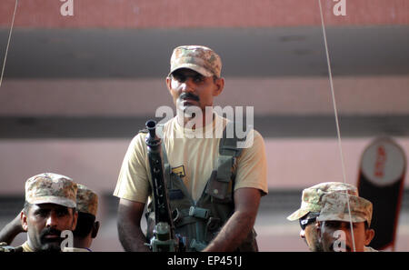 Karachi. 13th May, 2015. A Pakistani soldier stands guard at the attack site in southern Pakistani port city of Karachi on May 13, 2015. Pakistan Prime Minister Nawaz Sharif rushed to the port city of Karachi late Wednesday hours after terrorists brutally killed 45 people of minority Ismaili Shiite community, officially said. A group of six gunmen sprayed bullets indiscriminately inside a bus as the victims were heading to their worship place in the morning, police said. © Masroor/Xinhua/Alamy Live News Stock Photo