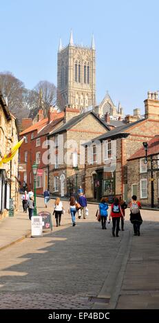 Lincoln, UK - April 9, 2015: Tourists head towards the Lincoln Cathedral, major landmark and the third largest cathedral the UK Stock Photo