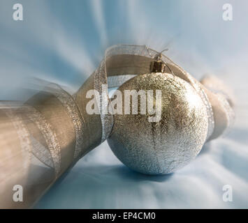 Beautiful silvery New Year's ball and elegant tinsel Stock Photo