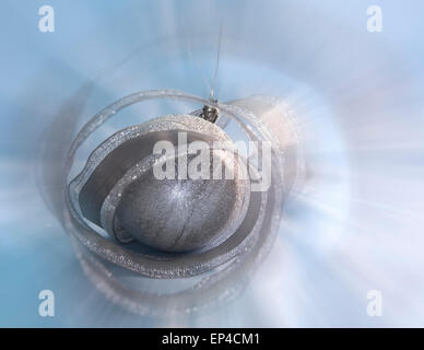 Beautiful silvery New Year's ball and elegant tinsel Stock Photo