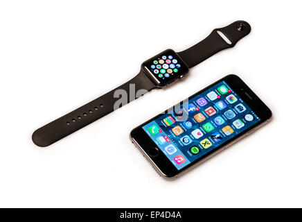 Ostfildern, Germany - May 13, 2015: The new Apple Watch, a black 42mm Apple Watch Sport displaying the apps screen next to the i Stock Photo