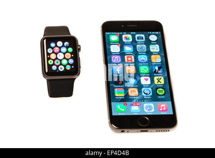 Ostfildern, Germany - May 13, 2015: The new Apple Watch, a black 42mm Apple Watch Sport displaying the apps screen next to the i Stock Photo