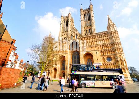 Lincoln, UK - April 9, 2015: Tour bus stops in front of the Lincoln Cathedral, major landmark and third largest cathedral in UK Stock Photo