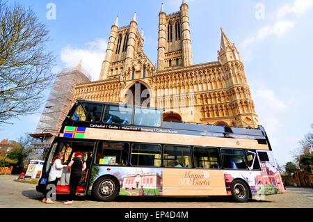 Lincoln, UK - April 9, 2015: Tour bus stops in front of the Lincoln Cathedral, major landmark and third largest cathedral in UK Stock Photo