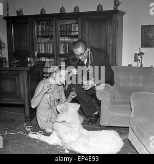 Deutsche Schauspielerin Katharina Mayberg mit ihrem Mann Alf Teichs und ihrem Hund bei einem Glas Sekt, Deutschland 1950er J Stock Photo