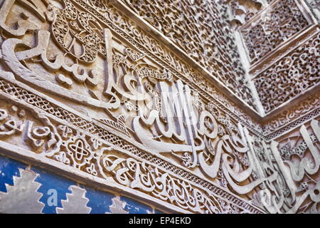 Fez, Medersa Bou Inania, Koranic school. Detail of the Zellij calligraphic frieze at courtyard. Morocco Stock Photo