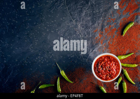 Chilli and garlic relish on black slate background from above Stock Photo