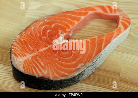 Close-up salmon steak on wooden plate Stock Photo