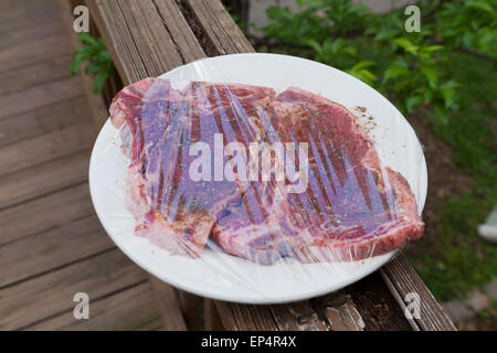 Raw beef steak wrapped and marinating - USA Stock Photo