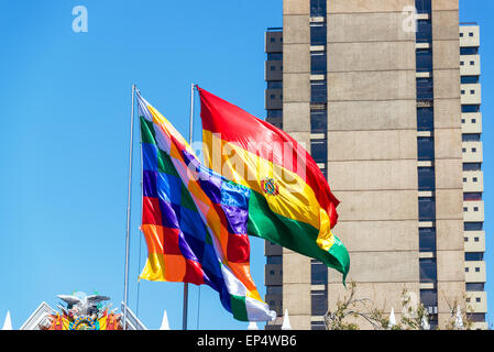 Two Bolivian flags blowing in the wind.  The checkered one is called a Wiphala Stock Photo