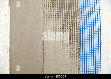 Closeup of facade layers over styro-foam insulation, mesh, plaster, cement, mortar - Shallow focus Stock Photo