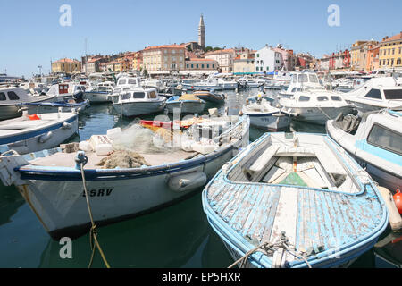 A large group of boats anchored in the marina with a view of the city promenade and the old city core in Rovinj, Croatia. Stock Photo