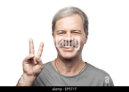 smiling mature man showing victory sign isolated Stock Photo