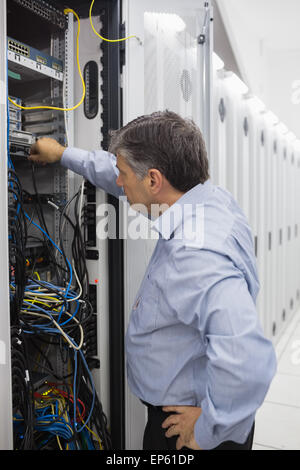Technician working on a case of server racks Stock Photo