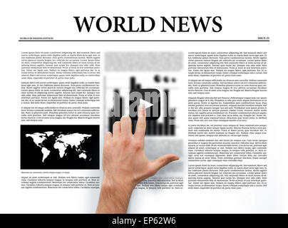 Hand pressing play button on digital newspaper Stock Photo