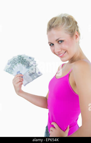 Young woman holding out fanned 100 euro banknotes Stock Photo