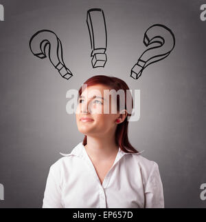 Young lady thinking with question marks overhead Stock Photo