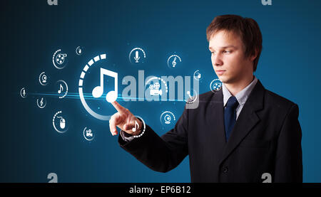 Businessman pressing virtual media type of buttons Stock Photo