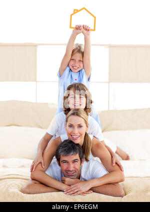 Jolly family having fun with yellow house illustration Stock Photo