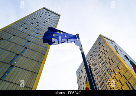 Golden twin towers of the Court of Justice of the European Union, in European Quarter, Kirchberg, Luxembourg, behind the EU flag Stock Photo