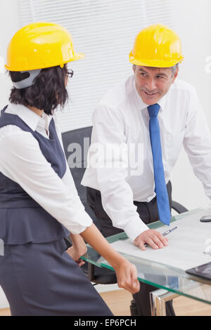 Two architects speaking with yellow helmet and smile Stock Photo