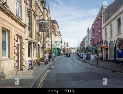 View looking up the High Street where shoppers are strolling Stock Photo