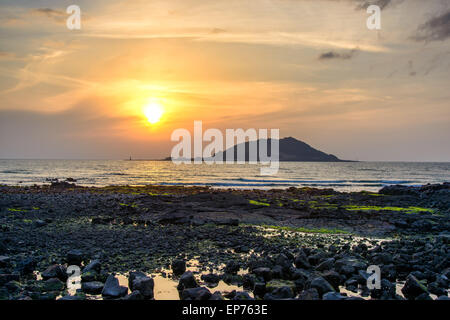 Sunset with Biyangdo island in a cloudy day, view from Hyeopjae beach in Aewol in Jeju Island, Korea. Stock Photo