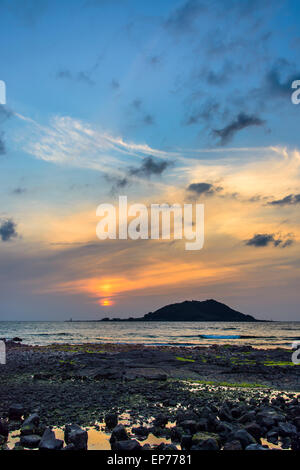 Sunset with Biyangdo island in a cloudy day, view from Hyeopjae beach in Aewol in Jeju Island, Korea. Stock Photo