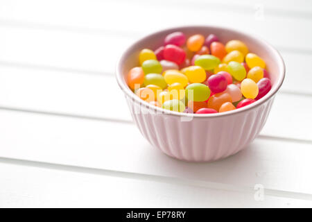 jelly beans in bowl on white table Stock Photo