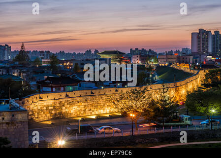 The sun sets behind Hwaseong Fortress in Suwon, South Korea. Stock Photo