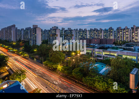 The sun sets over the endless apartment buildings among the suburbs of Seoul, South Korea. Stock Photo