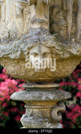 female face on decorative garden urn Stock Photo