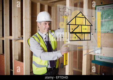 Architect using spirit level and looking at hologram interface Stock Photo