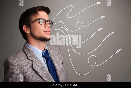 Attractive man looking at multiple curly arrows Stock Photo